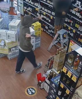 WATCH: Moment masked thief pulls knife on Gold Coast bottle shop worker