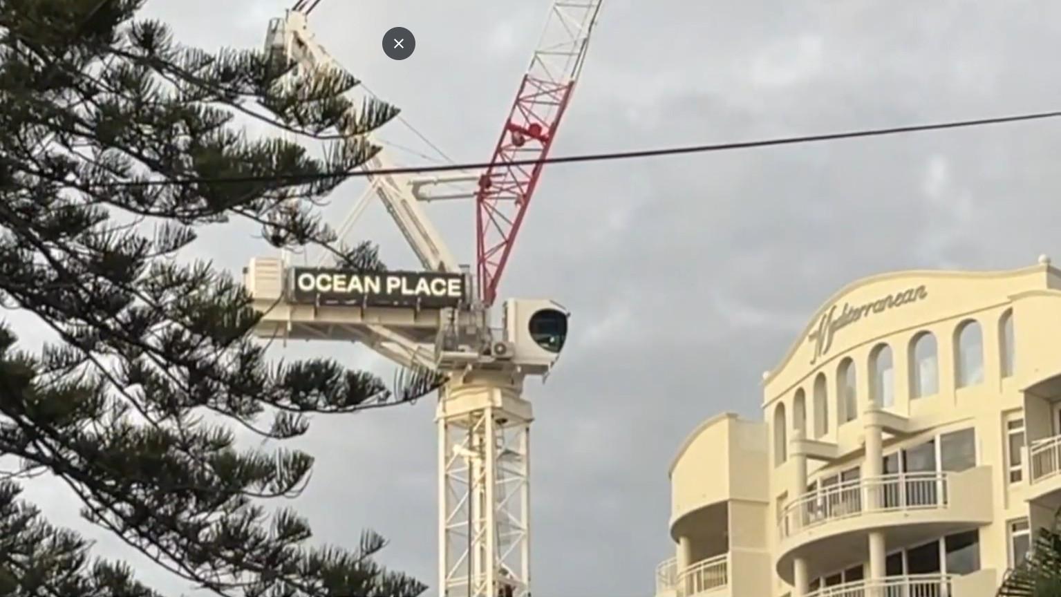 Police operation underway in Burleigh Heads after man climbs crane